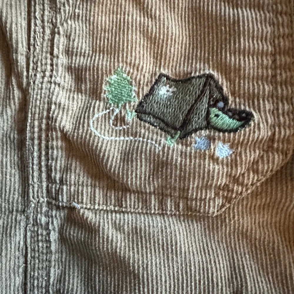Oshkosh B’gosh Boy’s Size 12M  Tan Overalls w Dinosaurs Embroidery
